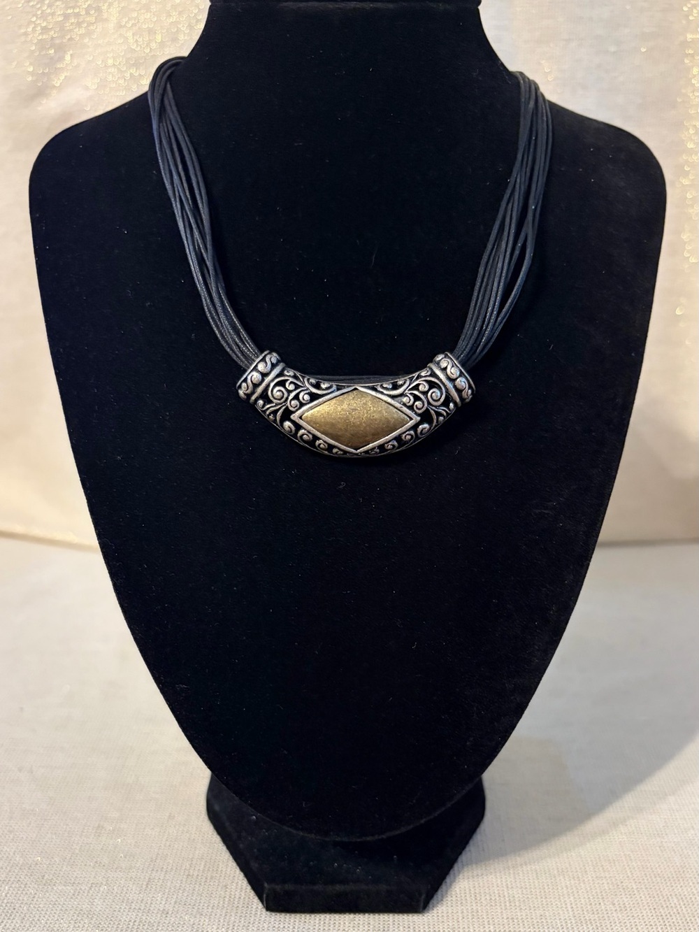 Gold and Black Statement Necklace with Ornate Silver Accent